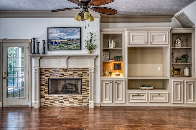 living room with a fireplace, a textured ceiling, crown molding, and dark hardwood / wood-style floors