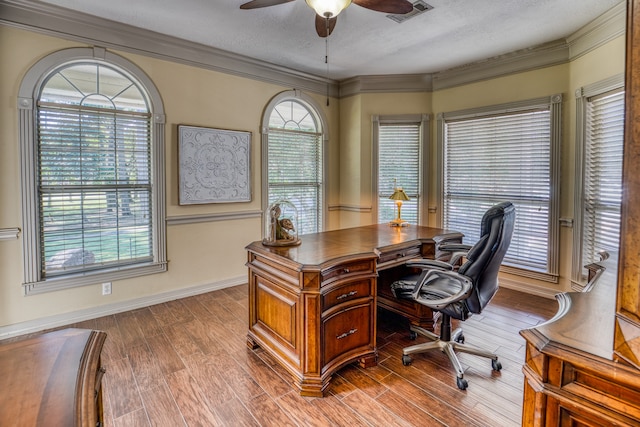 office featuring a textured ceiling, ceiling fan, hardwood / wood-style floors, and crown molding