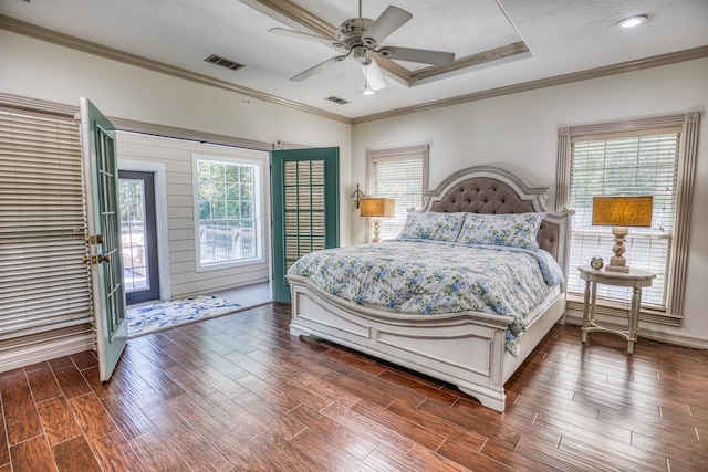 bedroom with a raised ceiling, ceiling fan, crown molding, and a textured ceiling