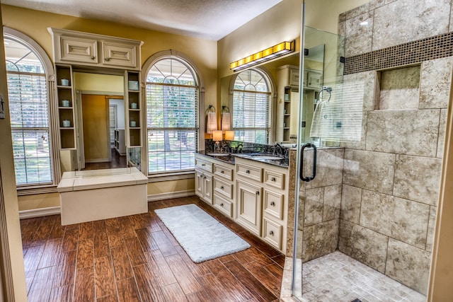 bathroom with hardwood / wood-style flooring, an enclosed shower, and vanity