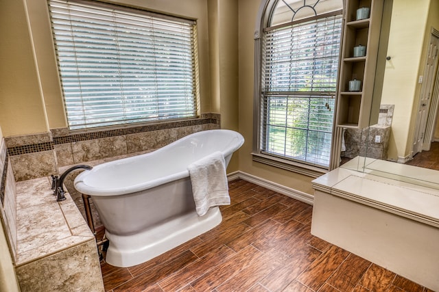 bathroom featuring a bath and a wealth of natural light