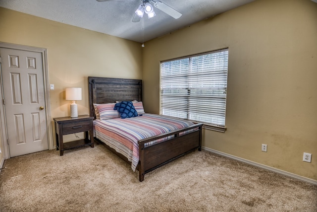 carpeted bedroom with a textured ceiling and ceiling fan