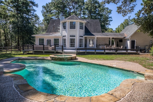 view of pool with an in ground hot tub and a wooden deck