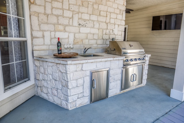 view of patio / terrace with sink, area for grilling, and an outdoor kitchen