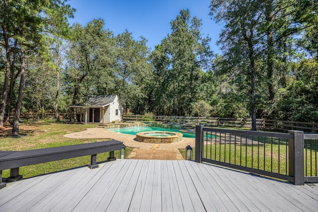 wooden terrace featuring a storage unit, a swimming pool with hot tub, and a lawn