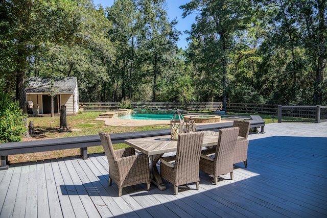 wooden deck with a shed and a swimming pool with hot tub