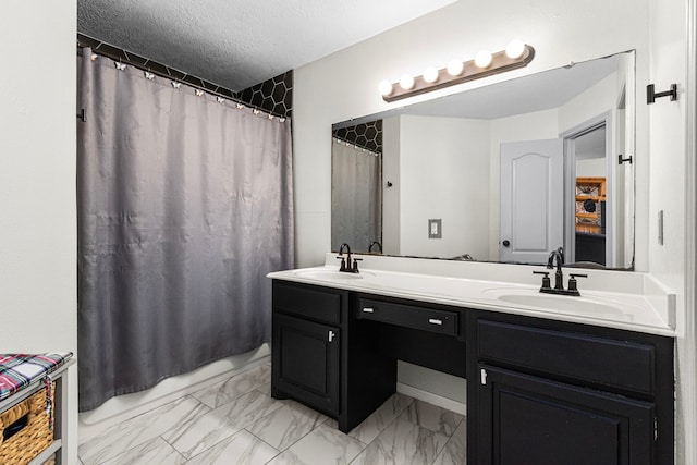 bathroom with a shower with curtain, vanity, and a textured ceiling