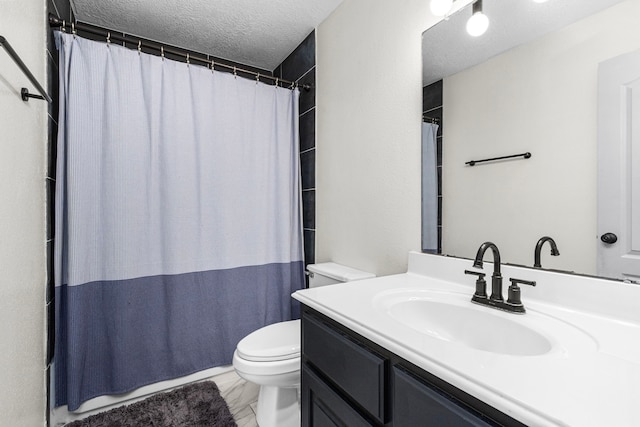 bathroom with a shower with curtain, a textured ceiling, vanity, and toilet