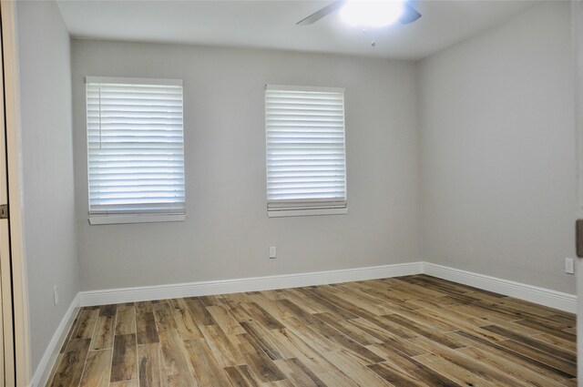 unfurnished room with ceiling fan and hardwood / wood-style flooring