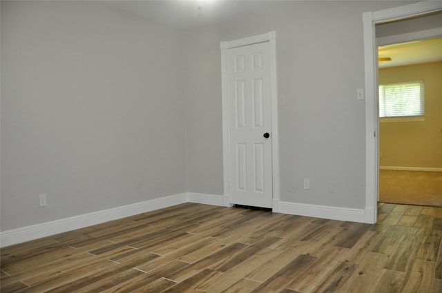 unfurnished room with hardwood / wood-style flooring