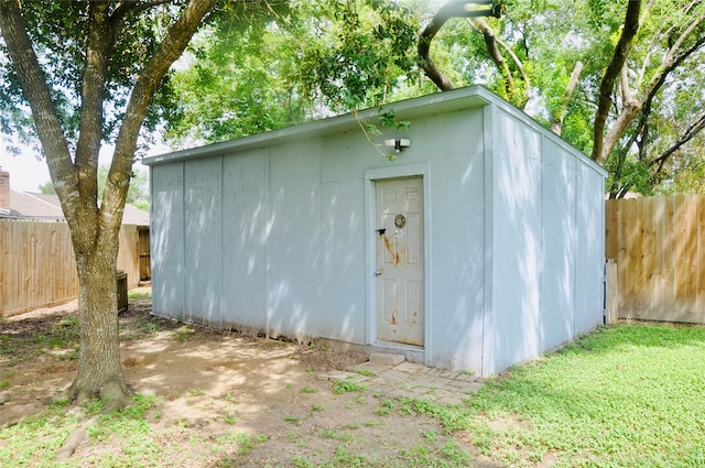 view of outbuilding with a yard