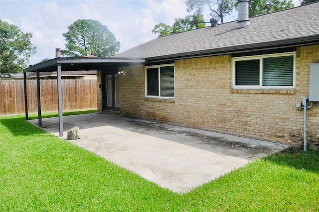 back of house with a patio and a yard