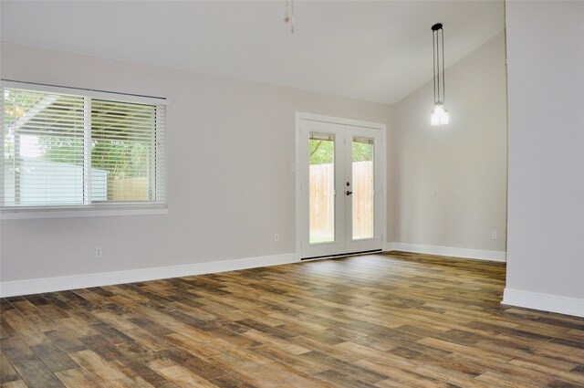 spare room with french doors, dark wood-type flooring, and vaulted ceiling