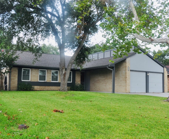 single story home featuring a front lawn and a garage