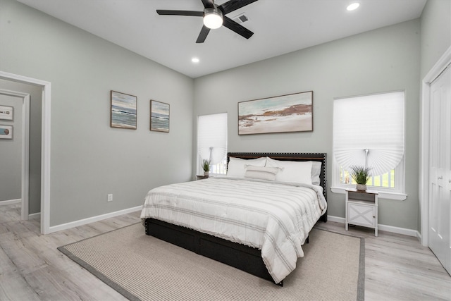 bedroom featuring light wood-type flooring, ceiling fan, and a closet