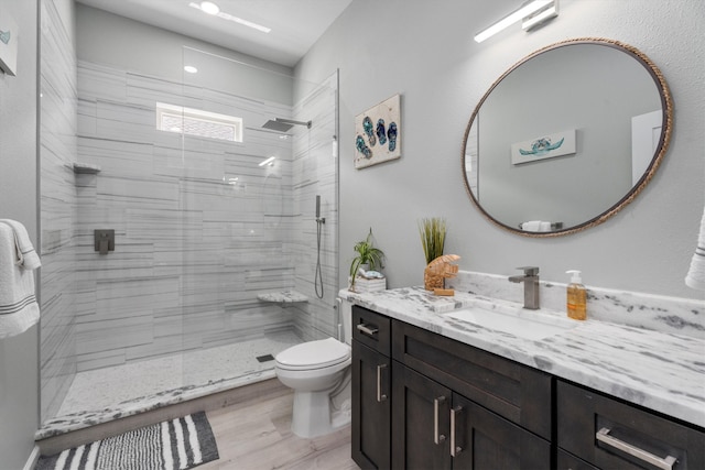 bathroom featuring hardwood / wood-style floors, a shower with shower door, vanity, and toilet