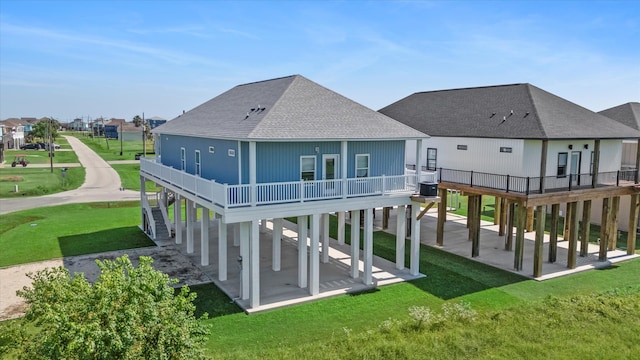 back of property with cooling unit, a yard, and a patio