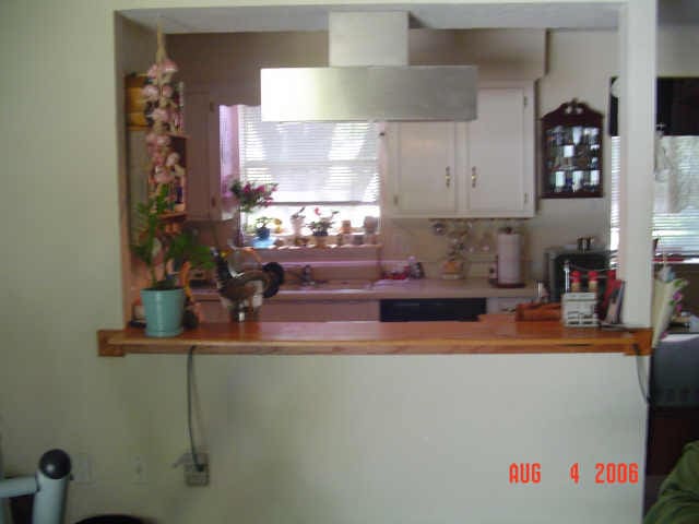 kitchen featuring ventilation hood, dishwasher, and white cabinets