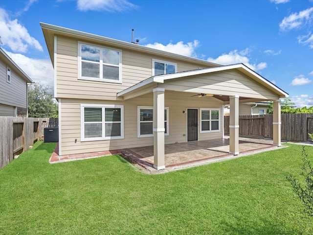 back of property with a yard, a patio, central AC unit, and ceiling fan