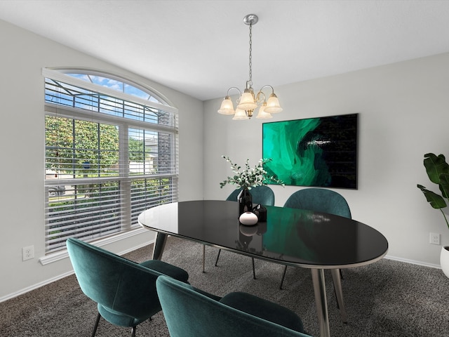 dining room with carpet and a chandelier