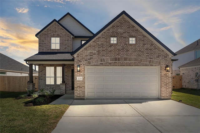 view of front of house featuring a garage, driveway, brick siding, and fence