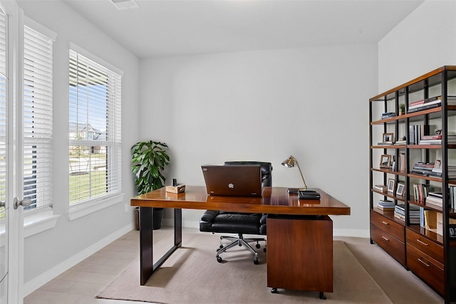 office space with a healthy amount of sunlight, baseboards, and wood finished floors