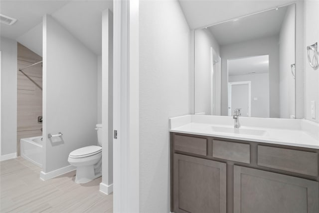 bathroom featuring toilet, visible vents, vanity, baseboards, and tub / shower combination