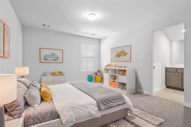 bedroom featuring baseboards, visible vents, and carpet flooring