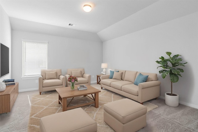 living room featuring lofted ceiling, light carpet, visible vents, and baseboards