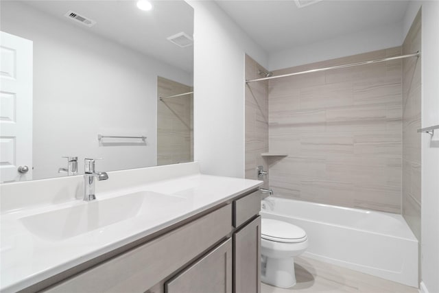 bathroom featuring toilet, visible vents, shower / bathing tub combination, and vanity