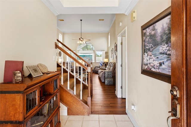 hallway with light hardwood / wood-style flooring and ornamental molding