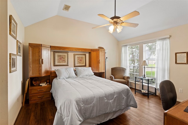 bedroom with vaulted ceiling, ceiling fan, and dark hardwood / wood-style flooring