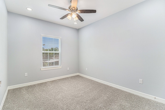 carpeted spare room with ceiling fan