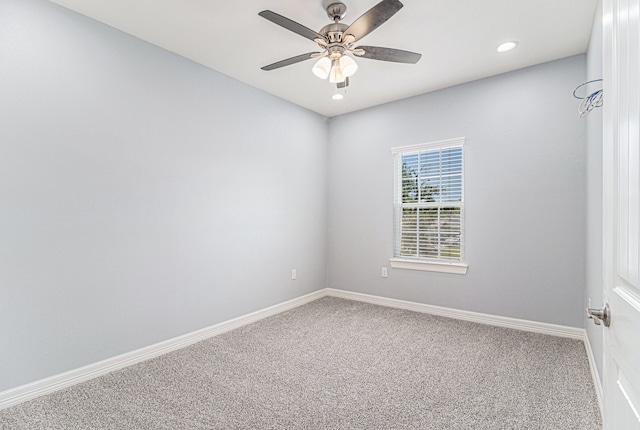 spare room featuring ceiling fan and carpet