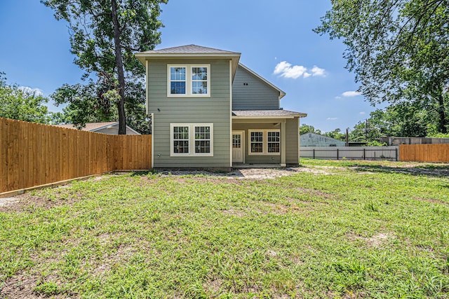 back of house featuring a yard