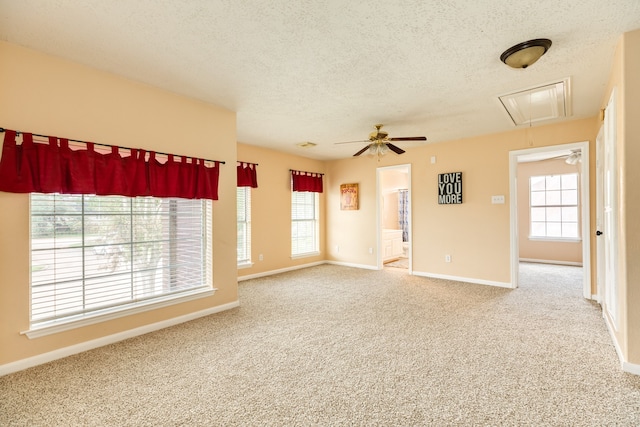 carpeted empty room featuring ceiling fan and a textured ceiling