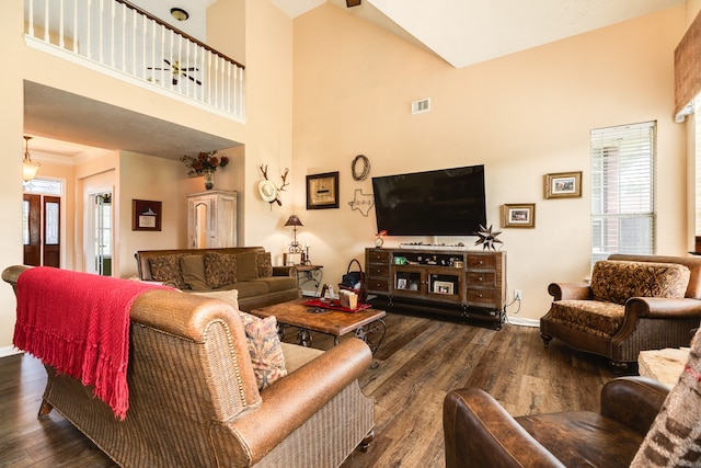 living room featuring high vaulted ceiling and dark wood-type flooring