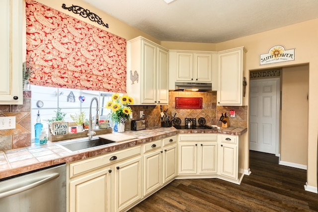 kitchen featuring decorative backsplash, tile counters, stainless steel dishwasher, dark hardwood / wood-style floors, and sink