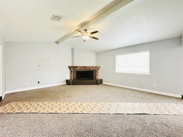 unfurnished living room with vaulted ceiling with beams, carpet flooring, ceiling fan, and a brick fireplace