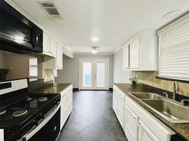 kitchen featuring white cabinets, sink, black range, crown molding, and decorative backsplash