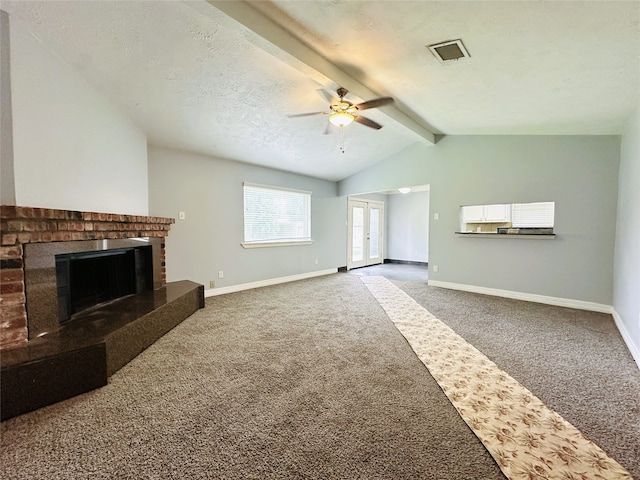 unfurnished living room featuring ceiling fan, carpet flooring, a brick fireplace, a textured ceiling, and lofted ceiling with beams