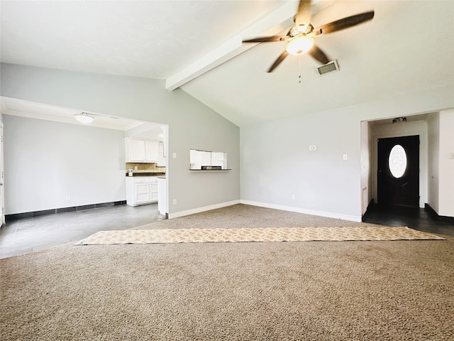 unfurnished living room with ceiling fan, lofted ceiling with beams, and dark carpet