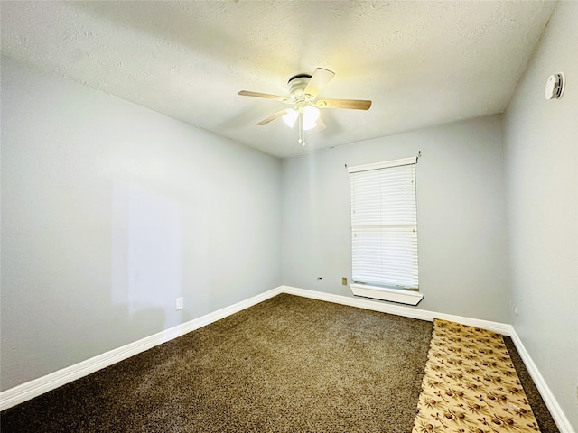 carpeted empty room featuring ceiling fan and a textured ceiling