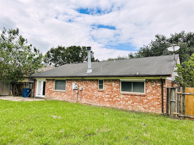 rear view of house with a yard