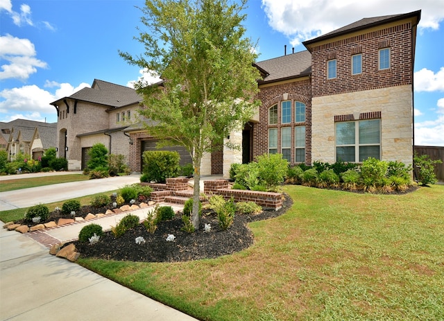 view of property with a garage and a front lawn