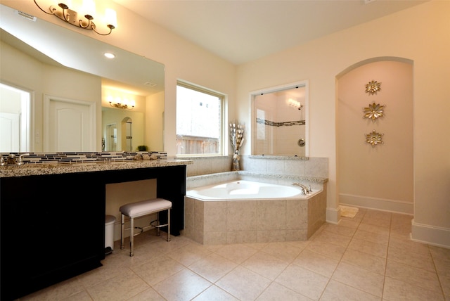 bathroom featuring vanity, shower with separate bathtub, and tile patterned flooring