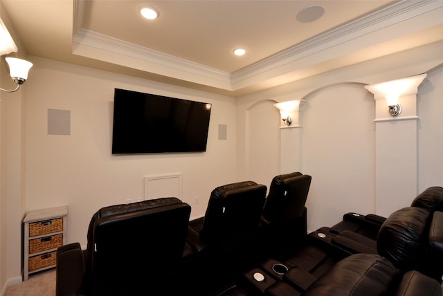 cinema room featuring a tray ceiling, carpet floors, and crown molding