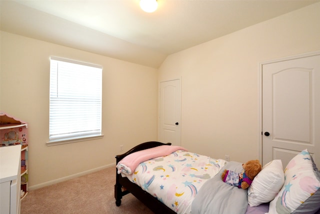 bedroom with light carpet and lofted ceiling