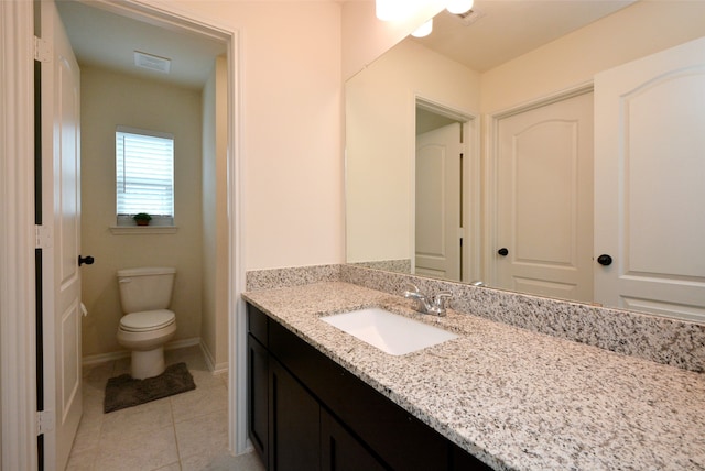 bathroom featuring tile patterned flooring, vanity, and toilet