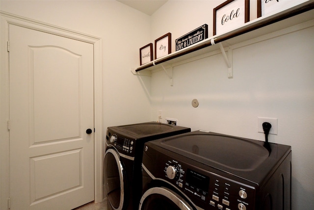 clothes washing area featuring washer and dryer